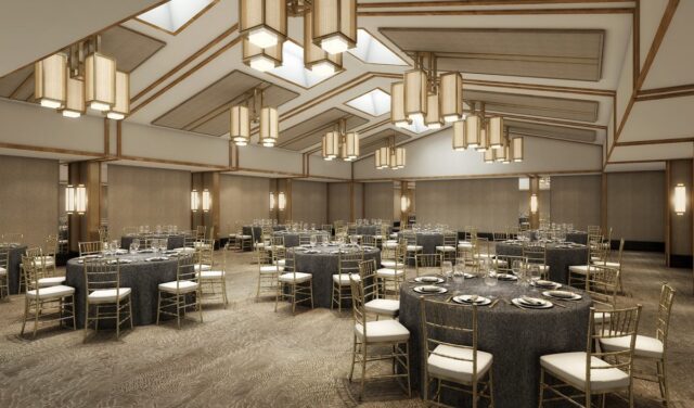 Large and modern event space with round tables at our Denver, CO hotel