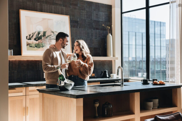 Couple enjoying coffee in bed at our Cherry Creek boutique hotel