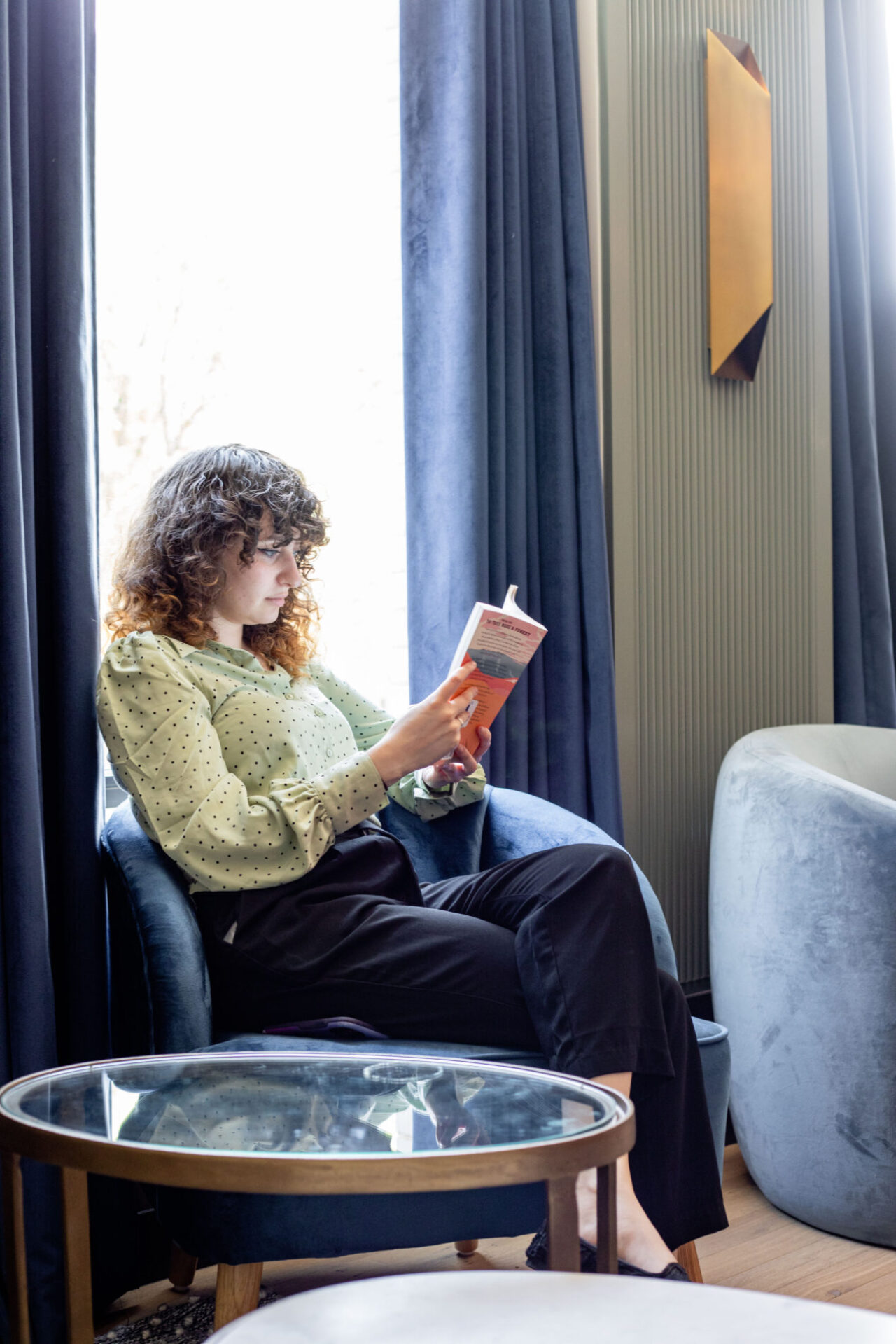 Person Reading at The Library at Clayton Members Club in Cherry Creek Denver