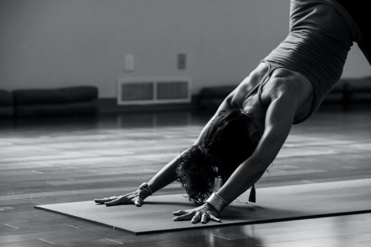 Grayscale image of a woman in a yoga pose at our Cherry Creek hotel