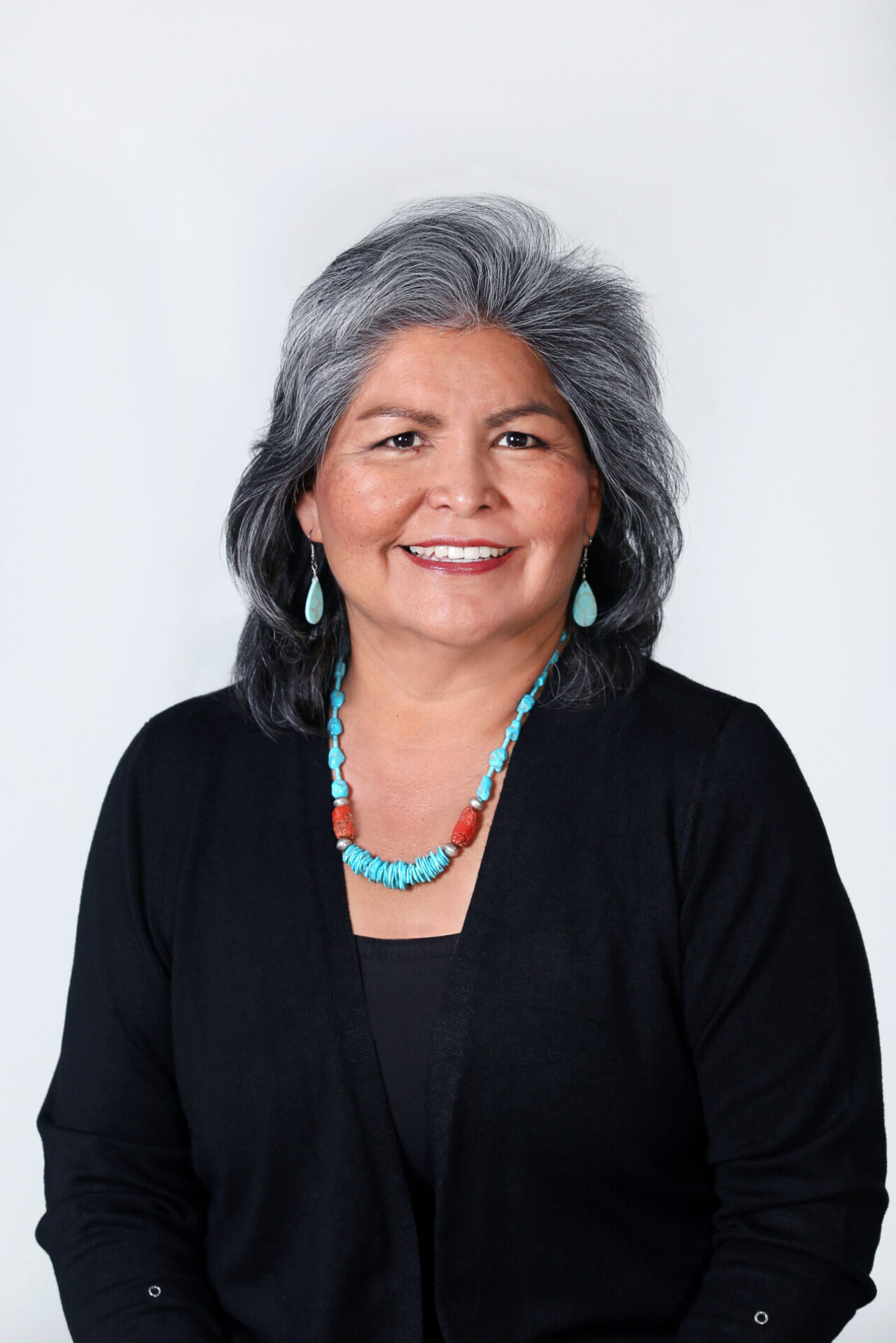 Portrait of a woman with gray hair and turquoise jewelry