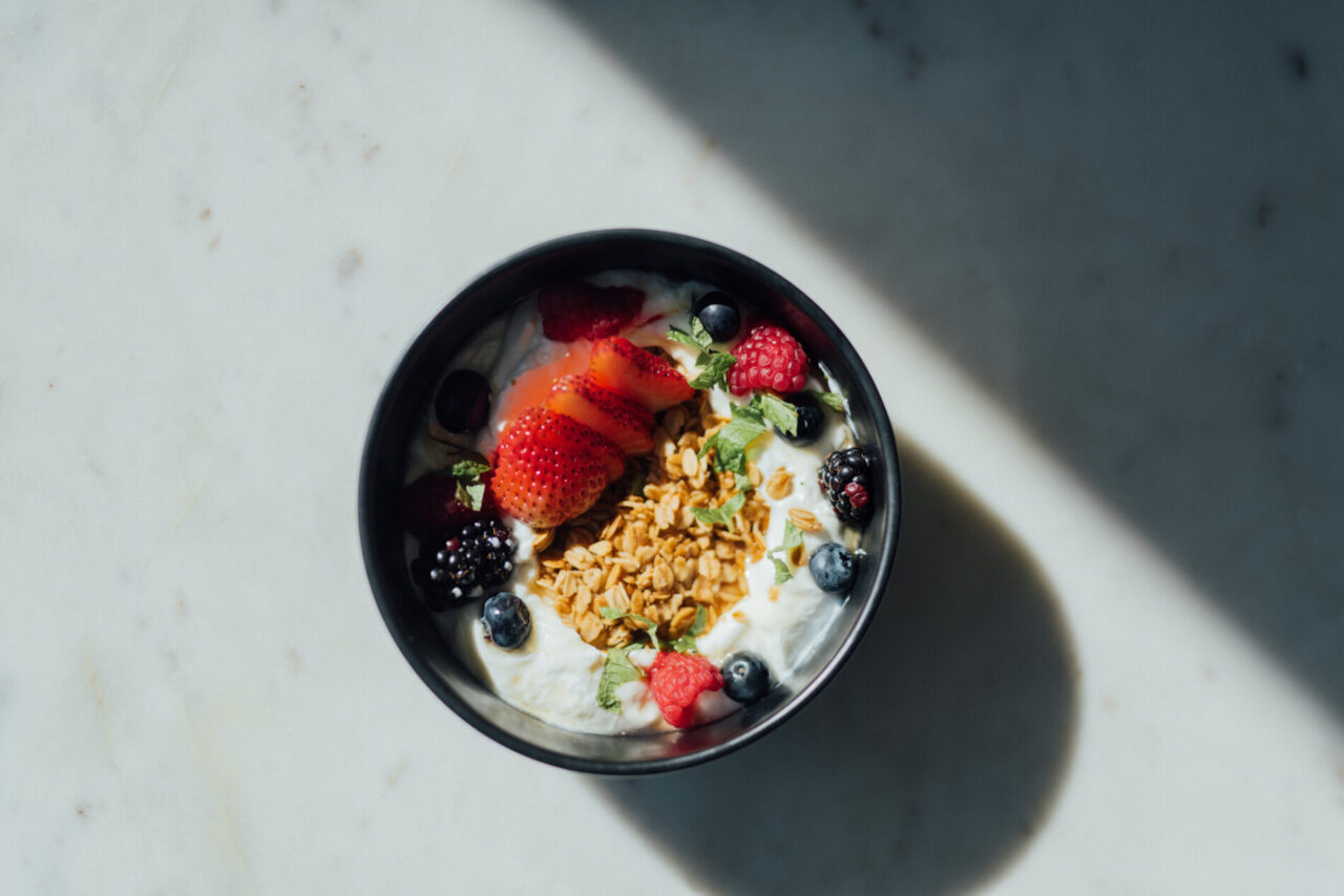 Bowl of yogurt with fresh fruit and granola at our boutique hotel in Denver