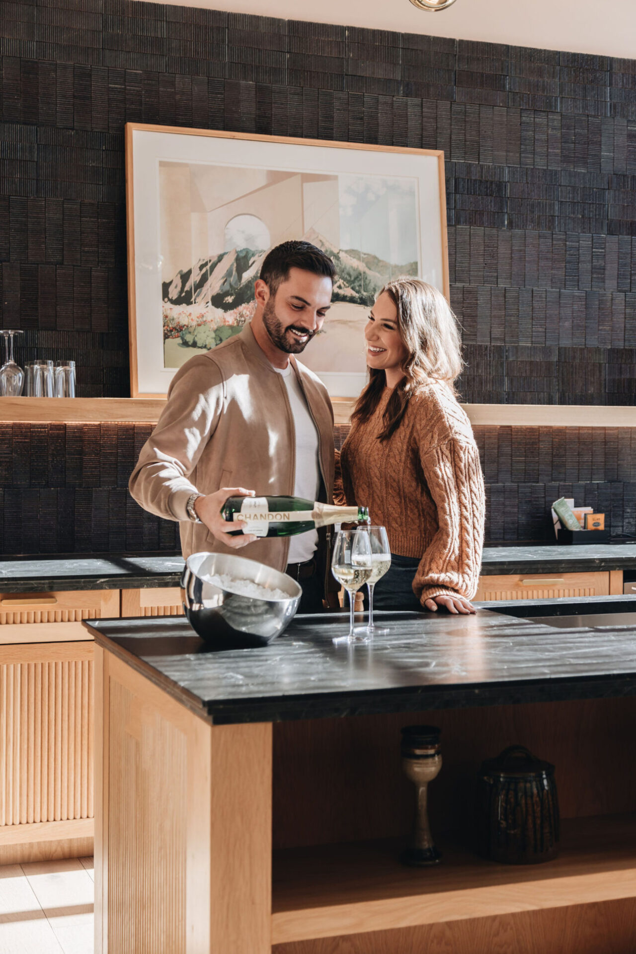 Couple pouring champagne in presidential suite